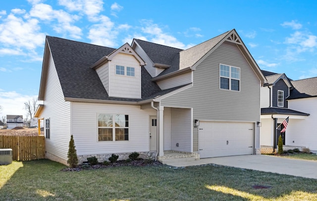 view of front of home with a garage, a front yard, and central air condition unit