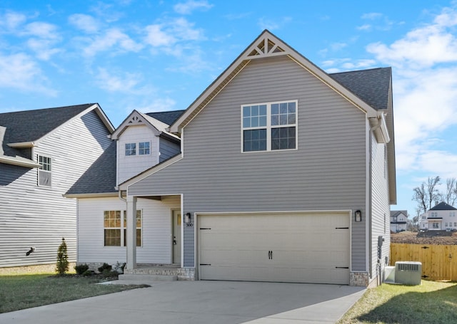 view of front of house with a garage, central AC unit, and a front lawn