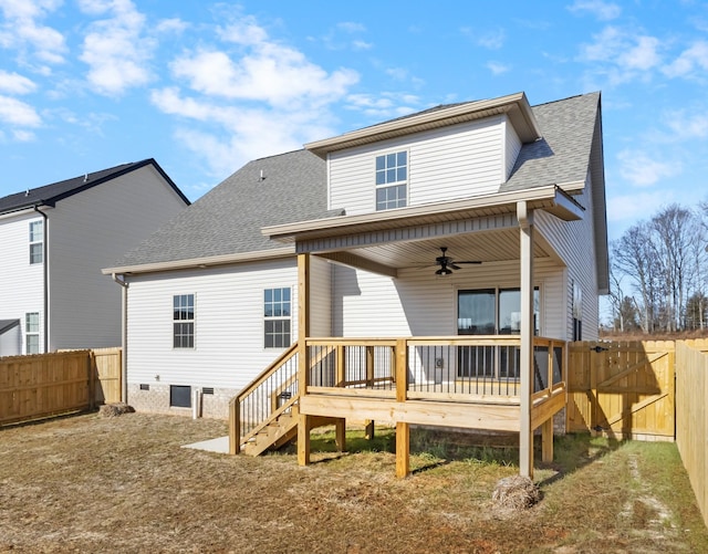 rear view of house with a wooden deck, a yard, and ceiling fan