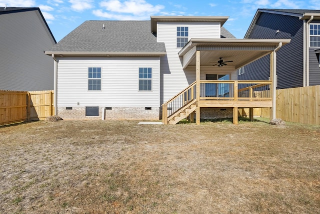 rear view of house with a wooden deck, ceiling fan, and a lawn