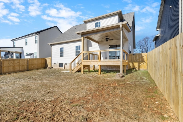 back of property featuring ceiling fan and a deck