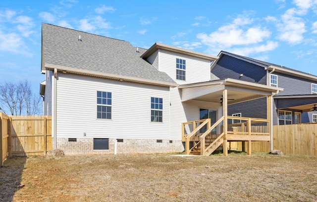 rear view of property featuring a yard, a deck, and ceiling fan