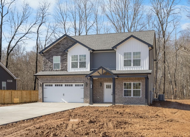 view of front of home with central AC and a garage