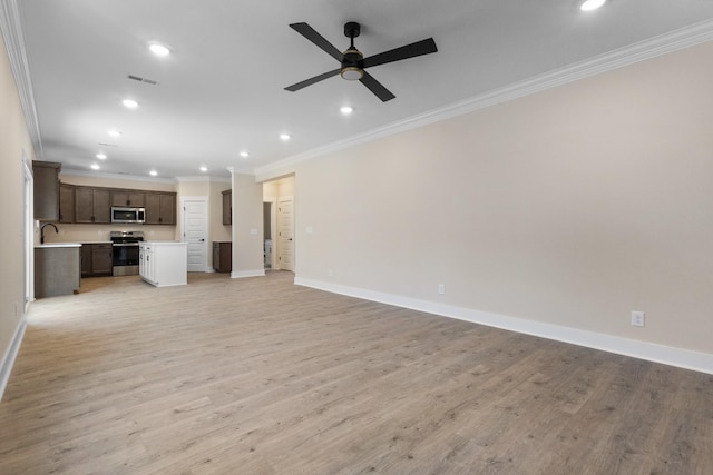 unfurnished living room featuring ornamental molding, sink, ceiling fan, and light hardwood / wood-style flooring