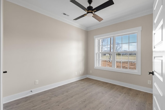 spare room featuring crown molding, light hardwood / wood-style floors, and ceiling fan