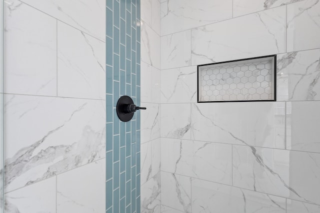 bathroom with tiled shower