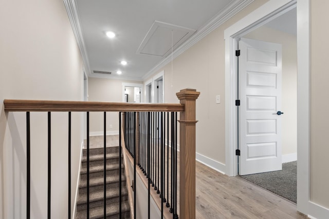 stairway featuring hardwood / wood-style flooring and ornamental molding