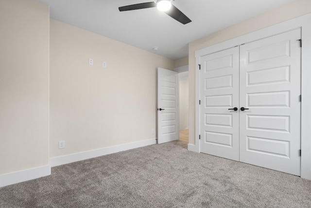 unfurnished bedroom featuring carpet floors, a closet, and ceiling fan