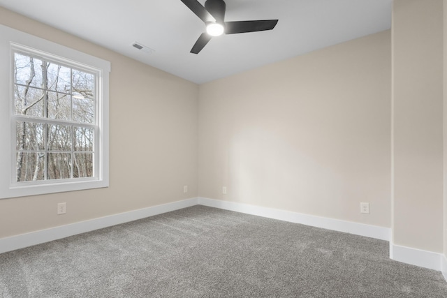 carpeted spare room with ceiling fan