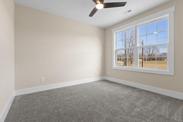 spare room featuring ceiling fan and carpet