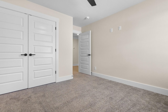 unfurnished bedroom with light colored carpet, ceiling fan, and a closet