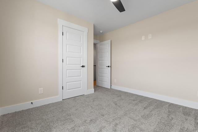 carpeted empty room featuring ceiling fan