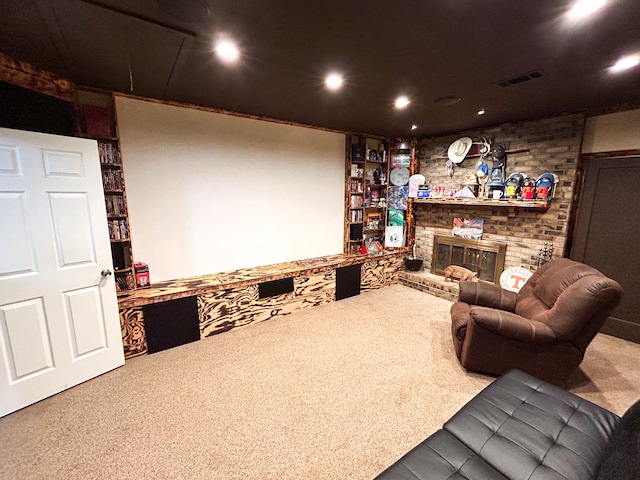 cinema room with carpet floors and a brick fireplace