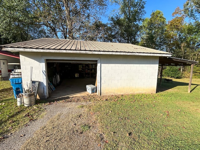 garage featuring a lawn