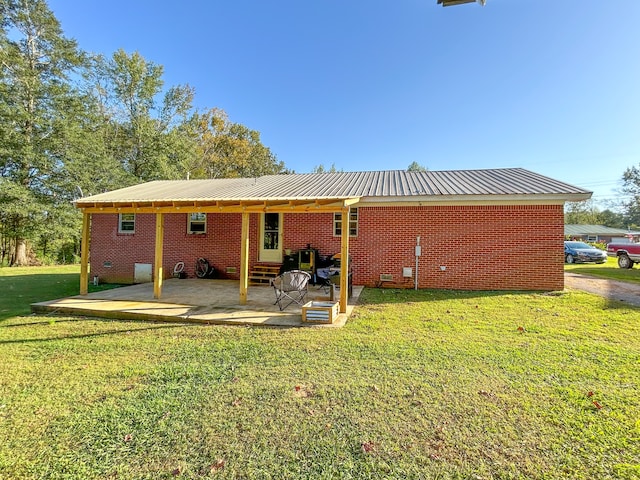 rear view of property featuring a patio and a yard