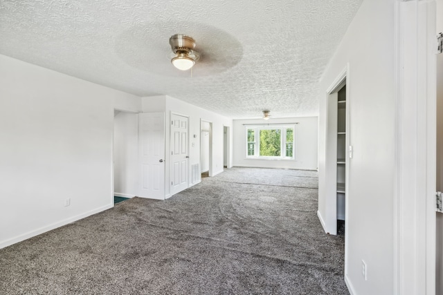 carpeted spare room with ceiling fan and a textured ceiling