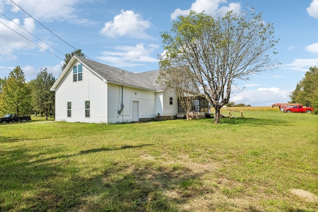 view of side of home featuring a lawn