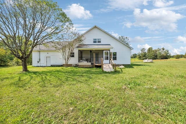 back of property featuring a lawn