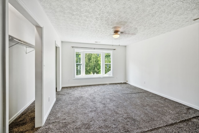 unfurnished bedroom with ceiling fan, a closet, carpet, and a textured ceiling