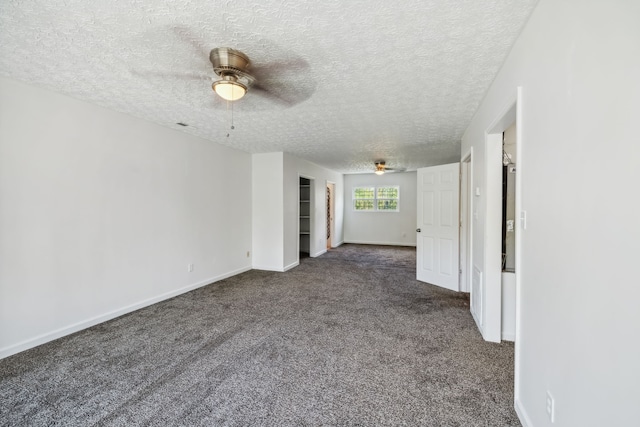 unfurnished room featuring dark carpet, a textured ceiling, and ceiling fan