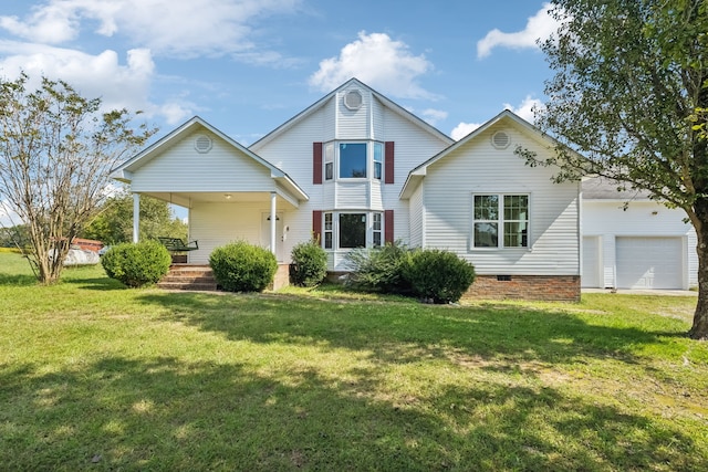 back of property with a garage, a porch, and a yard