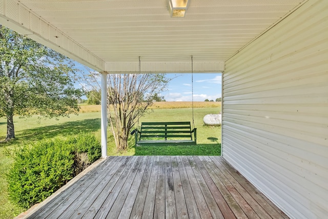 wooden terrace with a lawn