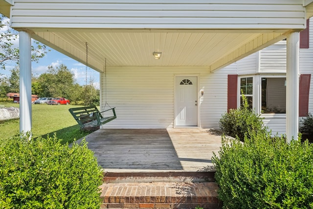 doorway to property featuring a lawn