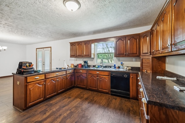 kitchen featuring kitchen peninsula, black dishwasher, dark hardwood / wood-style floors, and a textured ceiling