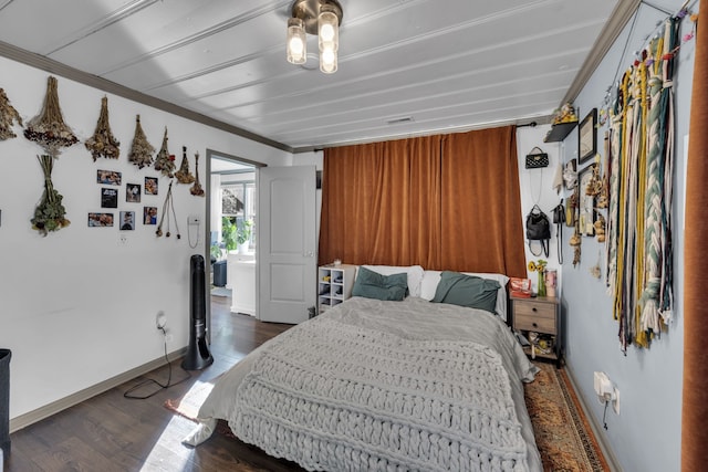 bedroom featuring ornamental molding and dark hardwood / wood-style floors