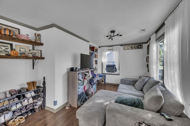 living room with crown molding and dark hardwood / wood-style flooring