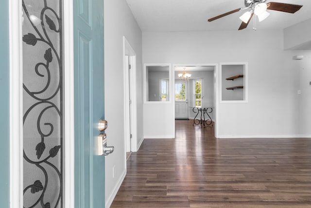 entryway with ceiling fan with notable chandelier and dark hardwood / wood-style flooring