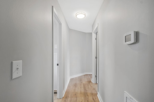 hallway with light hardwood / wood-style floors