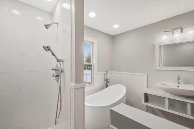 bathroom featuring vanity and separate shower and tub