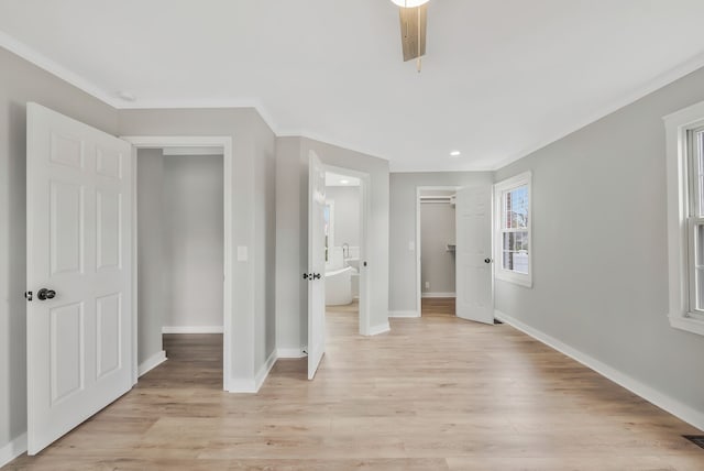 unfurnished bedroom featuring crown molding, ceiling fan, and light wood-type flooring