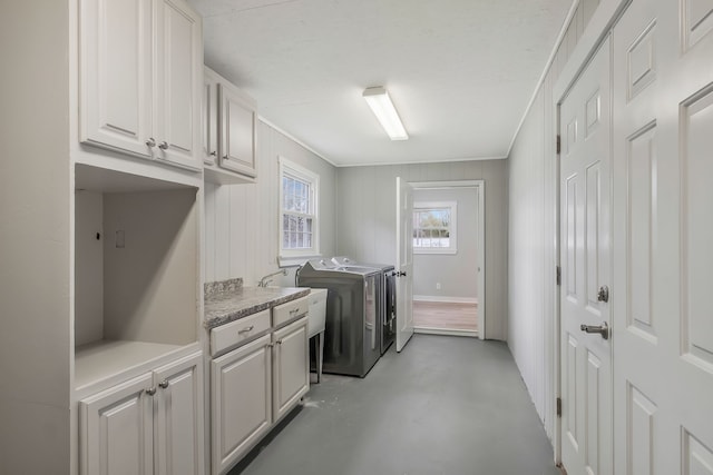 washroom featuring separate washer and dryer and cabinets