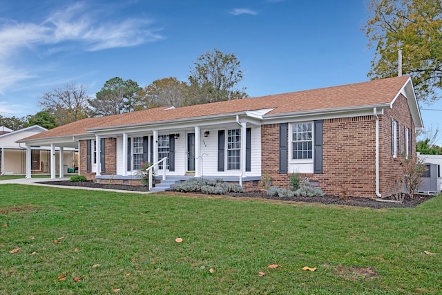 ranch-style home featuring covered porch, central AC, and a front lawn