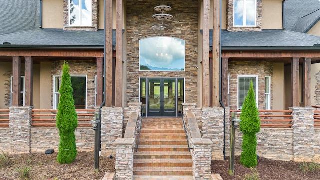 view of exterior entry with french doors and covered porch