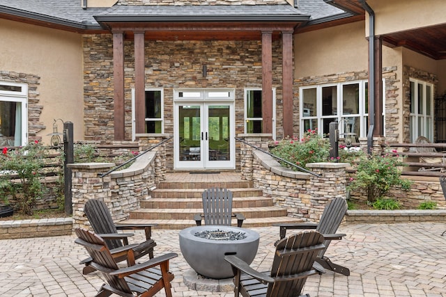 view of patio with french doors and a fire pit