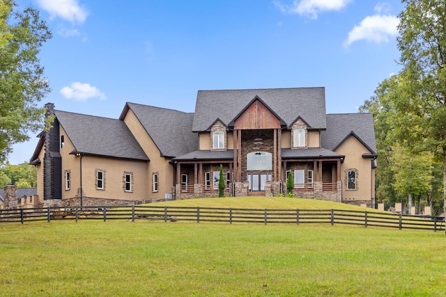 view of front facade with a front lawn and a rural view