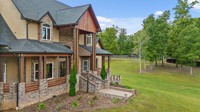 view of side of home with a yard