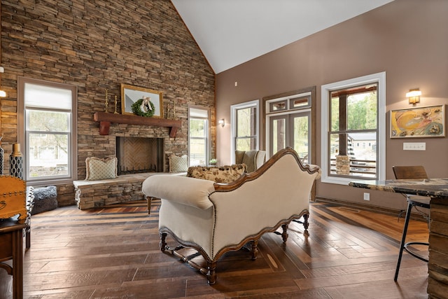 living room featuring dark hardwood / wood-style floors, high vaulted ceiling, and a fireplace