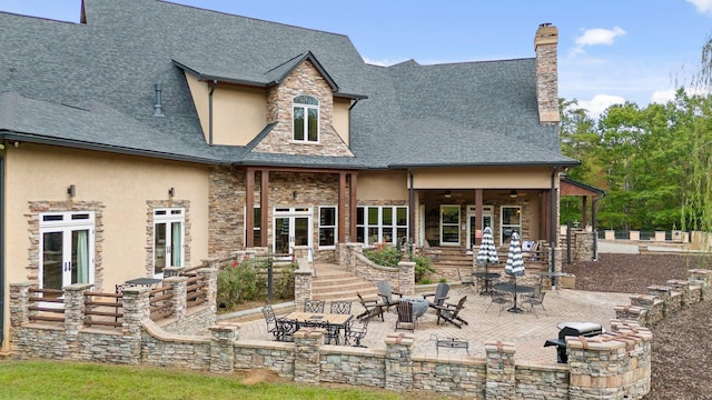 back of house featuring a patio and a fire pit