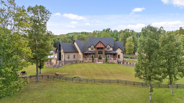 tudor home with a front yard and a rural view