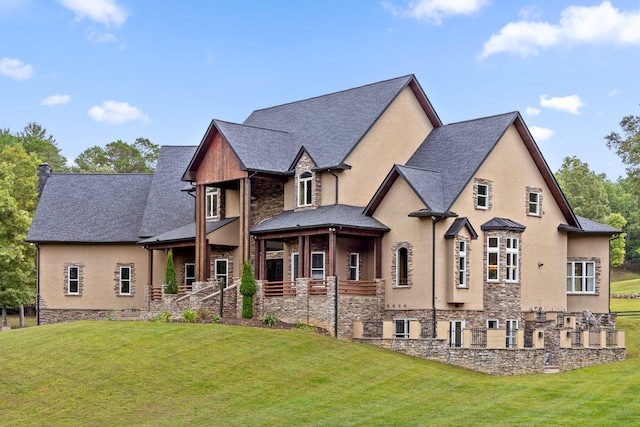 rear view of property with a lawn