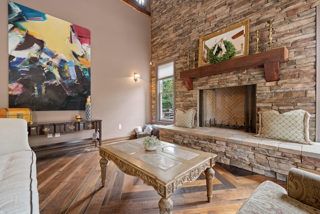 living room with a towering ceiling and a fireplace