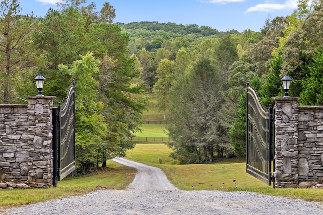 view of gate featuring a lawn