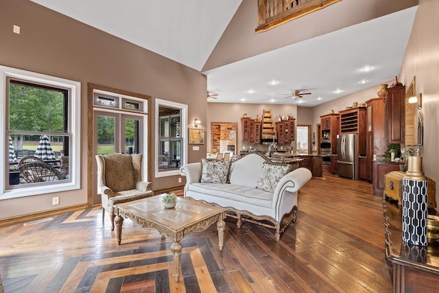 living room featuring ceiling fan, high vaulted ceiling, and dark hardwood / wood-style flooring