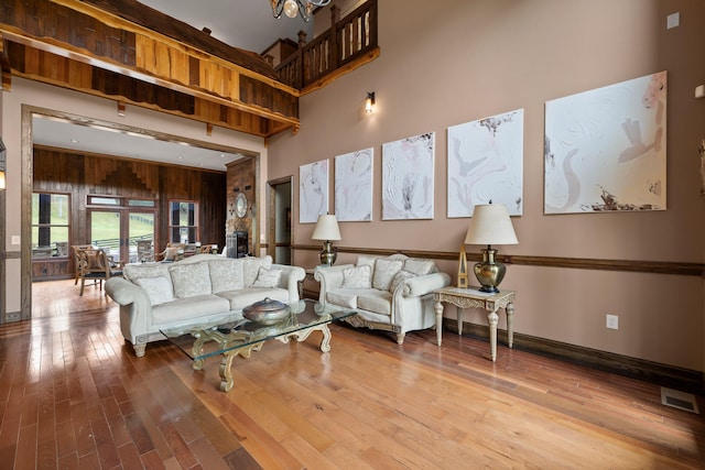 living room featuring light hardwood / wood-style floors and a high ceiling