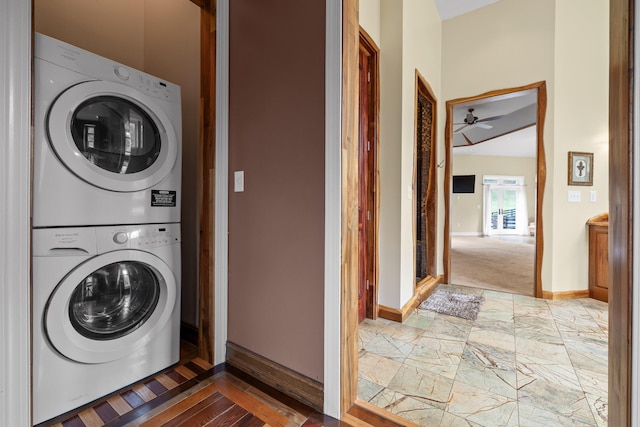 laundry area with stacked washer / drying machine and ceiling fan