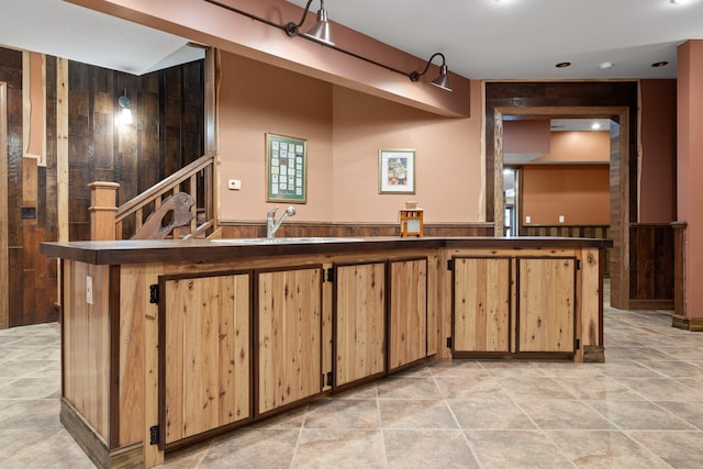 kitchen with wood walls and sink